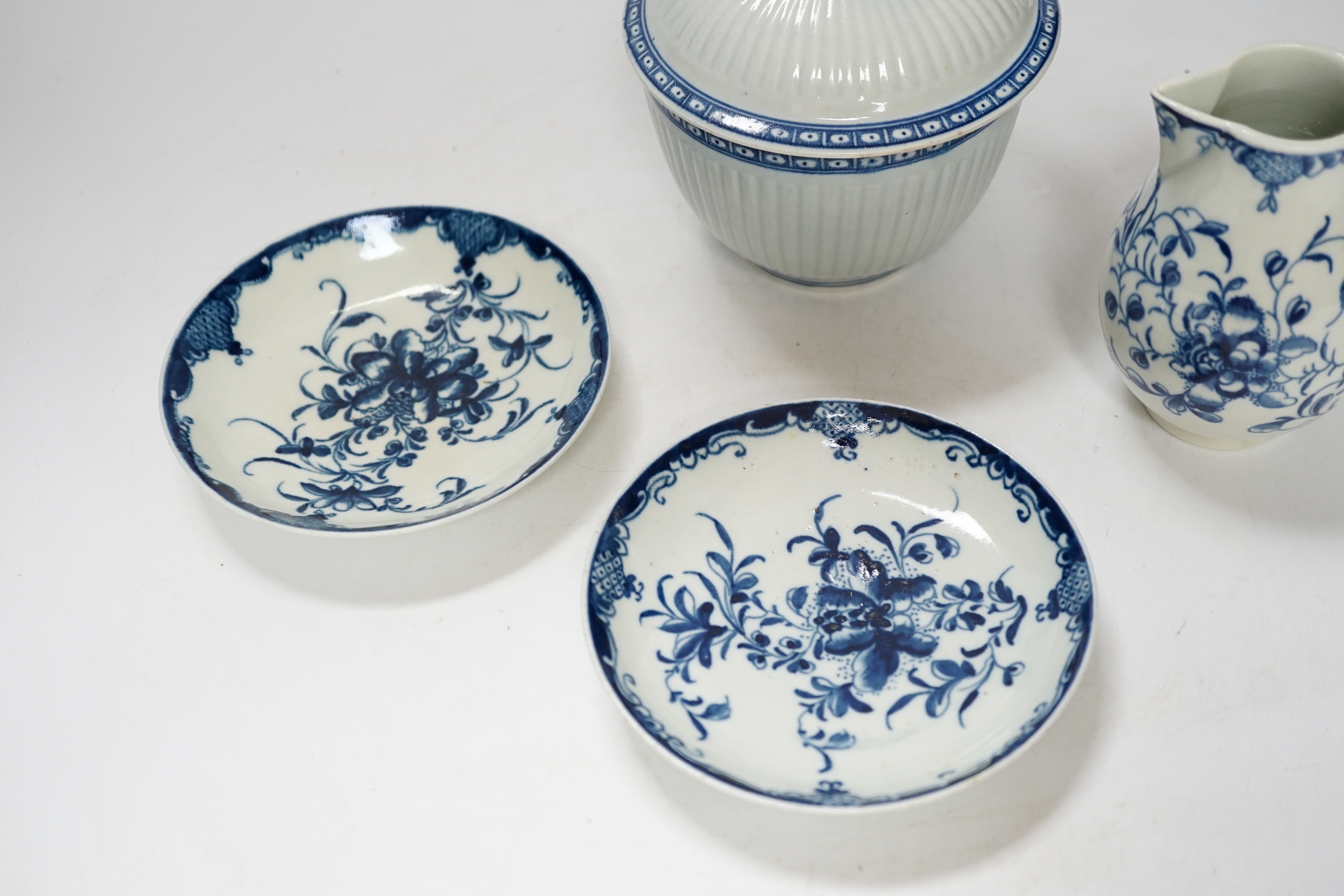 A Worcester Mansfield pattern sparrow beak milk jug, two saucers and a Worcester sucrier and cover, late 18th century